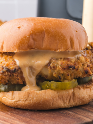 Homemade Chicken Big Mac copycat stacked tall with special sauce dripping down a sesame seed bun