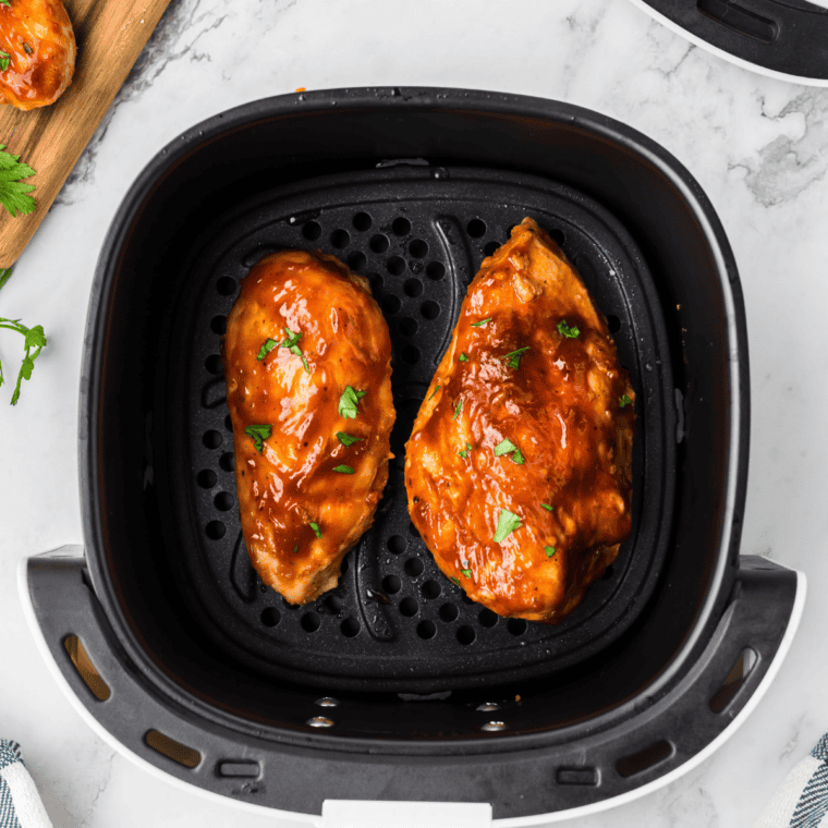 Honey bourbon marinated chicken caramelizing on the grill with a sticky glaze