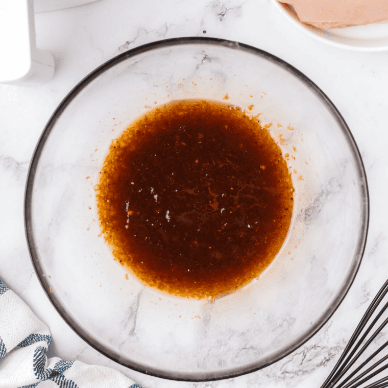 Chicken thighs marinating in copycat Lawry's honey bourbon marinade in a resealable bag