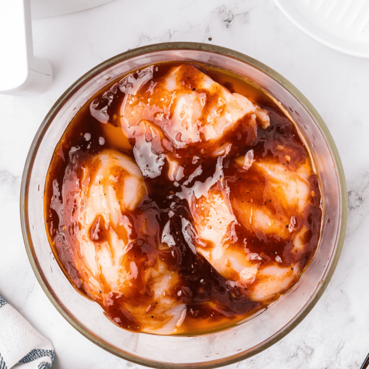Copycat Lawry's honey bourbon chicken brushed with sticky sauce on the grill