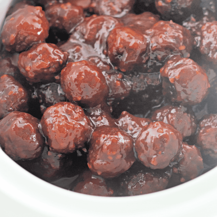 Jack Daniel's meatballs cooking in the slow cooker until glossy and glazed
