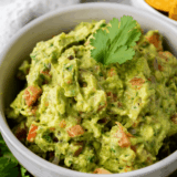 Ripe Hass avocados being mashed for an easy UK guacamole recipe