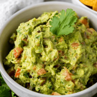 Ripe Hass avocados being mashed for an easy UK guacamole recipe