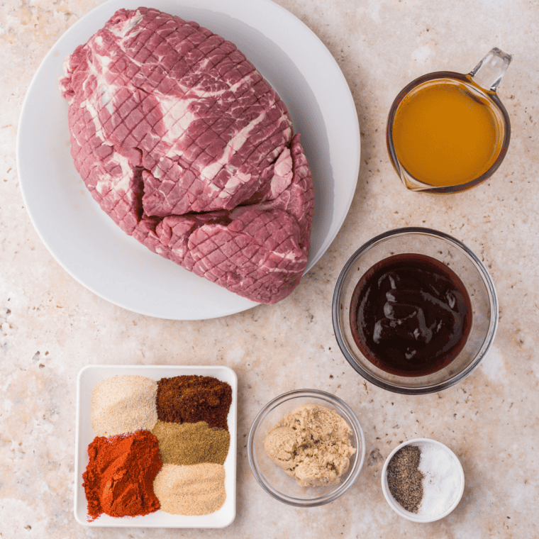 Ingredients for homemade Cuban complete seasoning laid out on a table — garlic powder, onion powder, cumin, oregano, coriander, and annatto