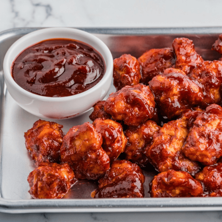 Finished Jack Daniel's sauce served as a dip next to crispy chicken nuggets.