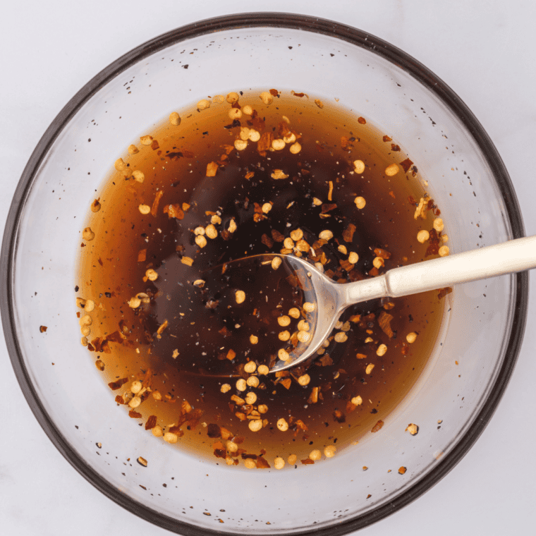 Stirring liquid smoke, cinnamon and spices into homemade brown sugar marinade