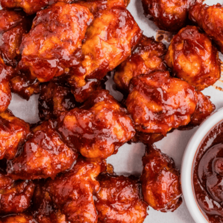 Air fryer chicken glazed with Copycat Stubb's Dr Pepper Barbecue Sauce, caramelized and juicy