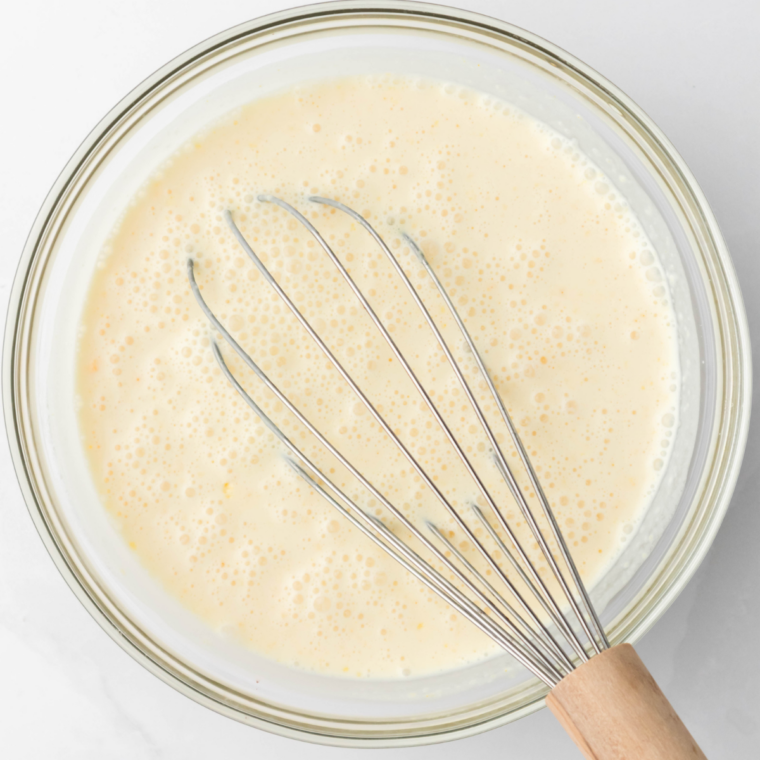 Whisking milk, cream, sugar, and vanilla in a bowl for Ninja Creami ice cream base
