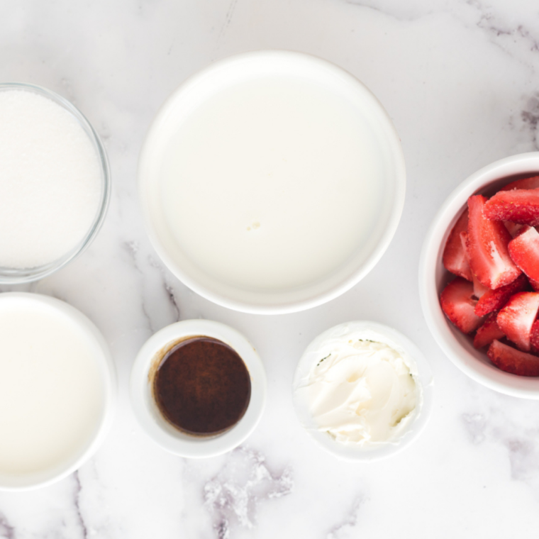 Diced fresh strawberries tossed with sugar and lemon juice in a small bowl, macerating for Blue Bell Strawberry ice cream