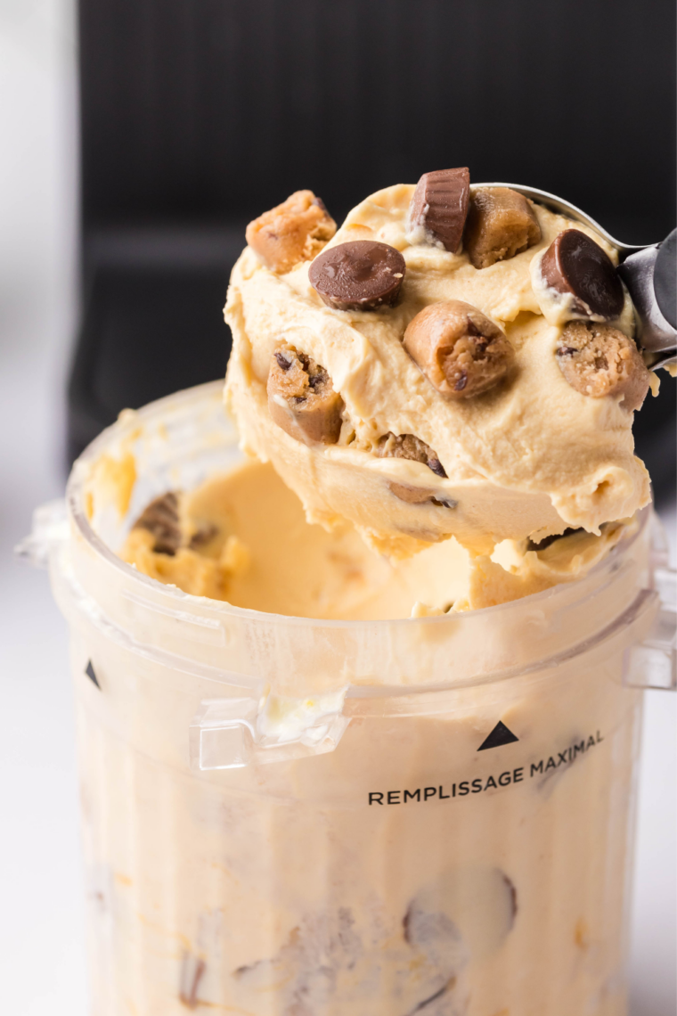 Ninja Creami Peanut Butter Cup Perfection ice cream scooped into a bowl and topped with peanut butter cups
