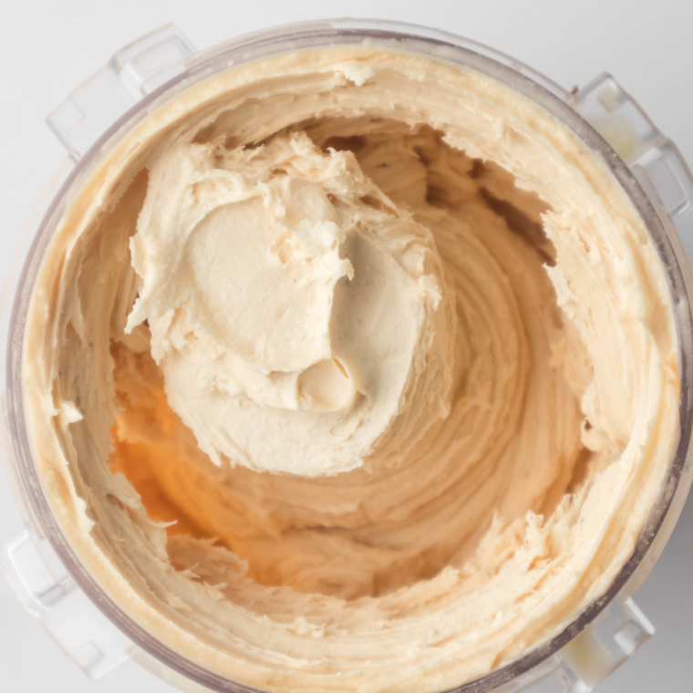 Ninja Creami pint locked into the machine to spin the frozen peanut butter cup base