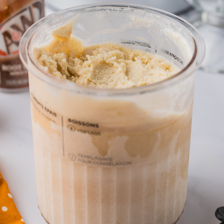 Ninja Creami root beer float Italian ice scooped into a cup and topped with whipped cream