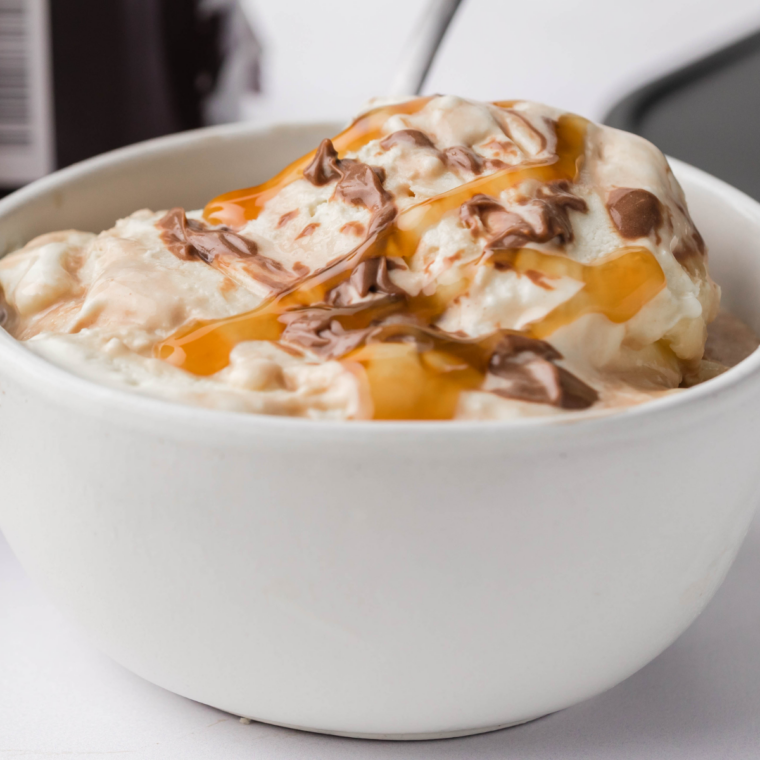 Scoop of Ninja Creami Talenti sea salt caramel gelato in a white bowl showing dense caramel ribbons