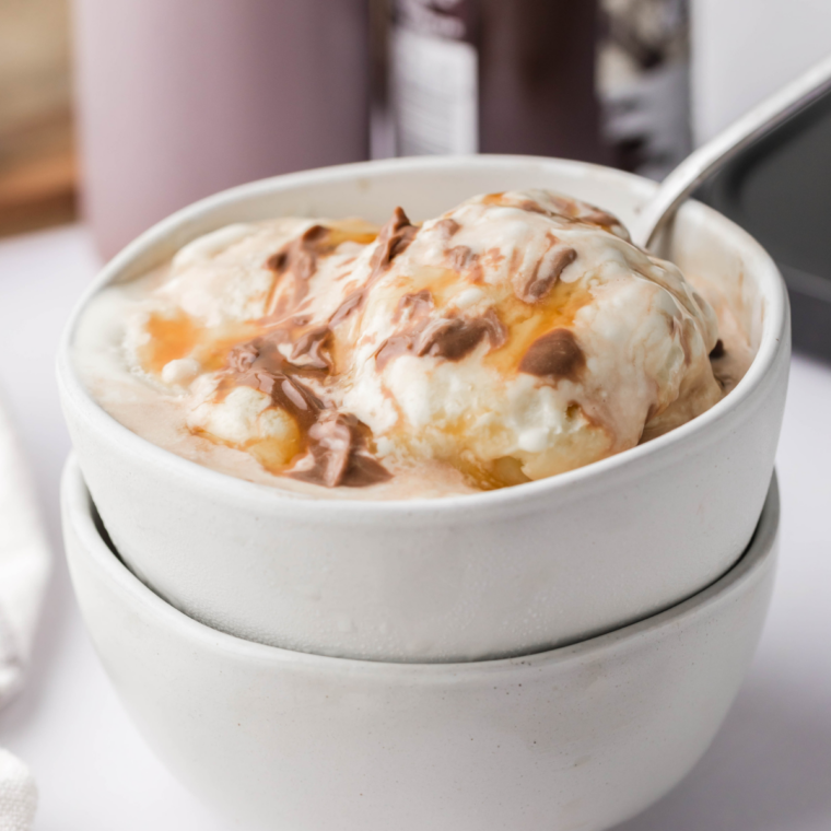 Ninja Creami Talenti sea salt caramel copycat gelato in a pint with caramel ribbons and flaky salt
