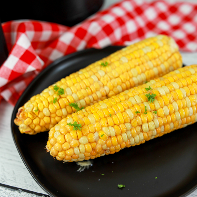 Street corn style Ninja Crispi corn with cotija cheese, chili powder, and lime wedges