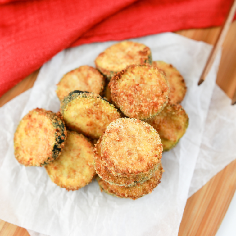 Close-up of crispy parmesan Ninja Crispi zucchini rounds ready to serve