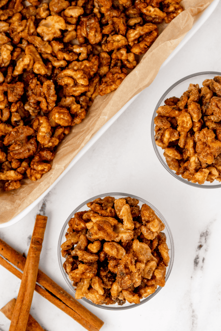Cooked candied coffee walnuts spread on a foil-lined baking tray