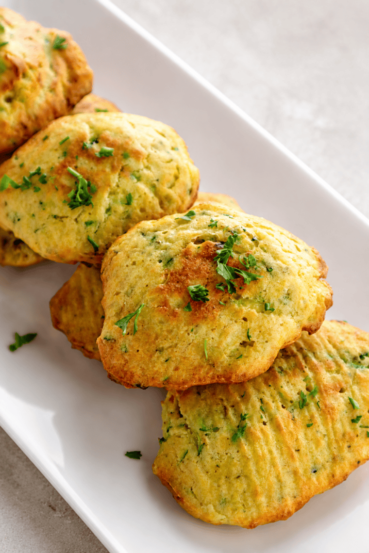Golden cooked zucchini squares on parchment paper in the air fryer basket