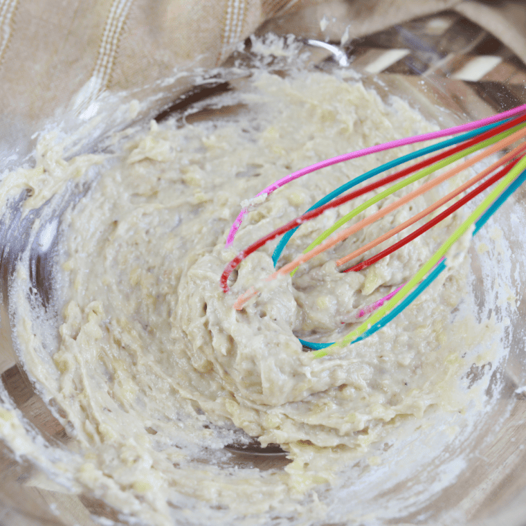 Melted butter, sugar, eggs, and sour cream whisked into mashed bananas until glossy