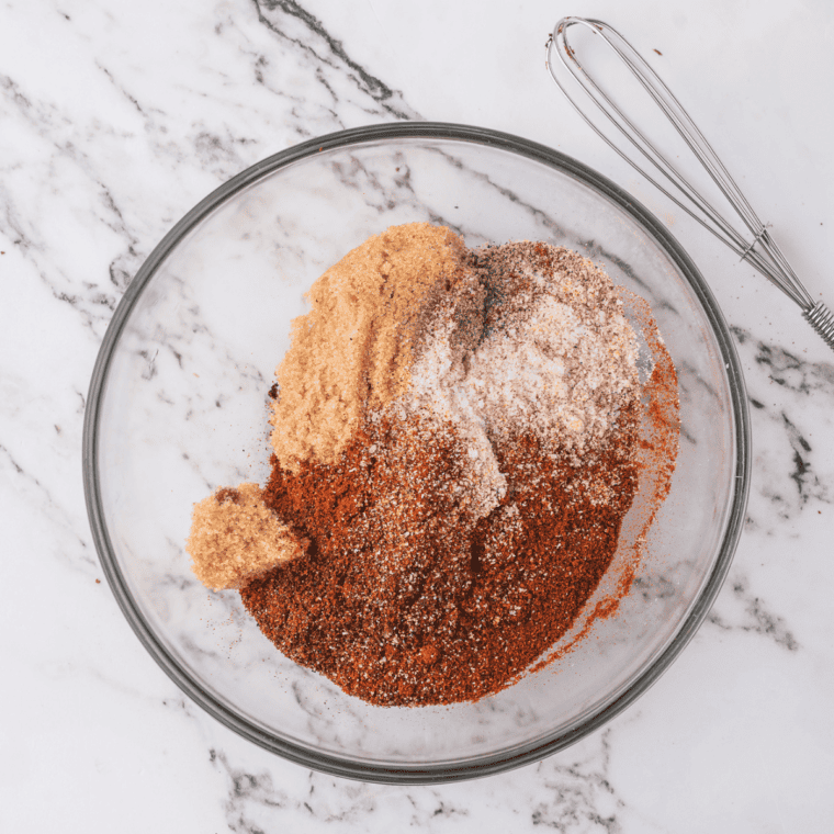 Bob Evans sausage seasoning ingredients in small bowls &mdash; rubbed sage, black pepper, thyme, marjoram, brown sugar, and crushed red pepper