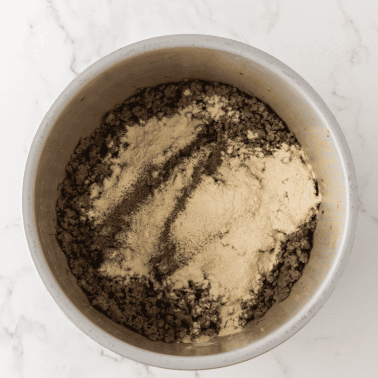 Flour sprinkled over browned sausage and stirred into a paste to make the roux for Bob Evans sausage gravy