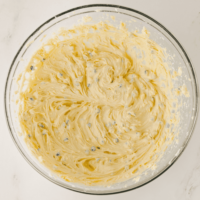 Cream cheese and butter beaten smooth in a glass mixing bowl with an electric hand mixer