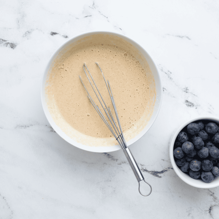 Whisking buttermilk, eggs, vanilla, and melted butter together in a glass bowl