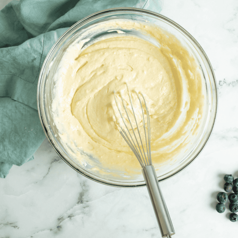 Whisking flour, sugar, baking powder, baking soda, and salt together in a large mixing bowl