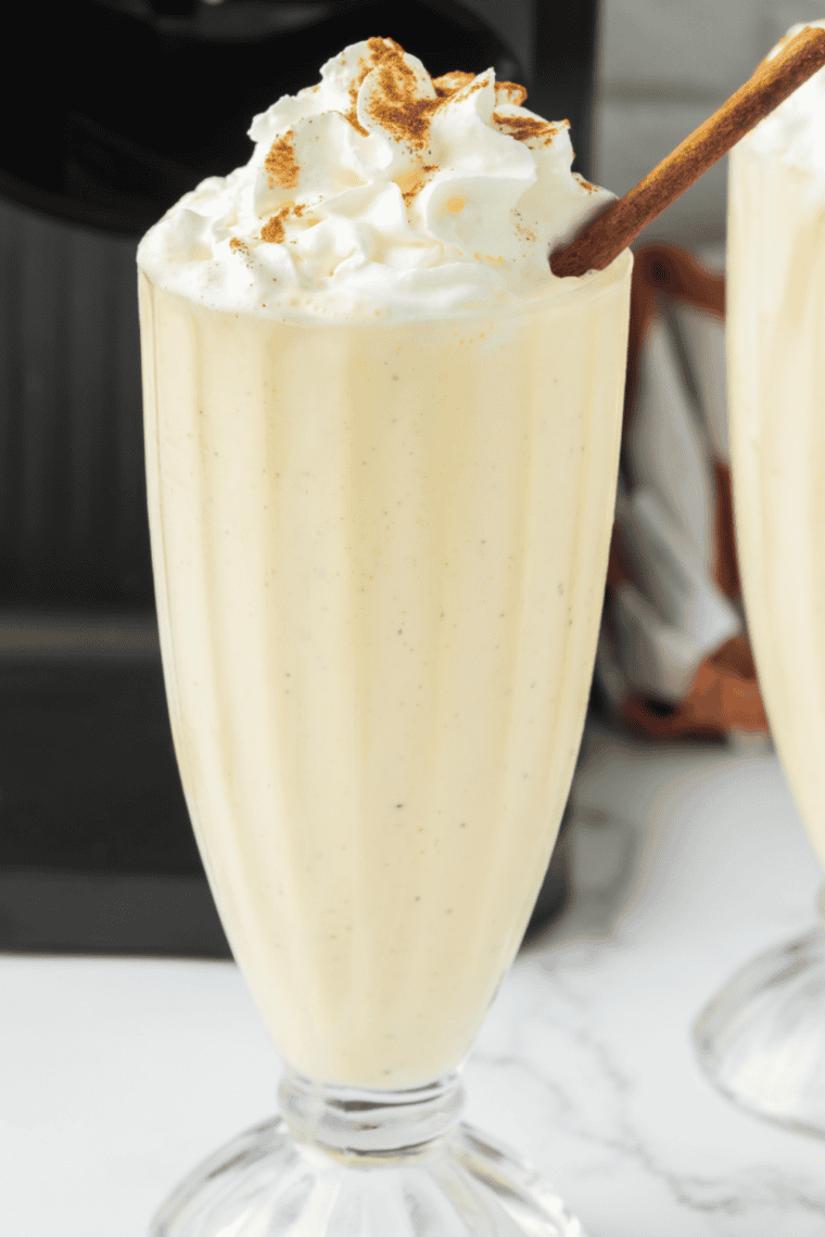 Thick Chick-fil-A Autumn Spice Milkshake copycat in a chilled glass, dusted with cinnamon and topped with a whipped cream swirl