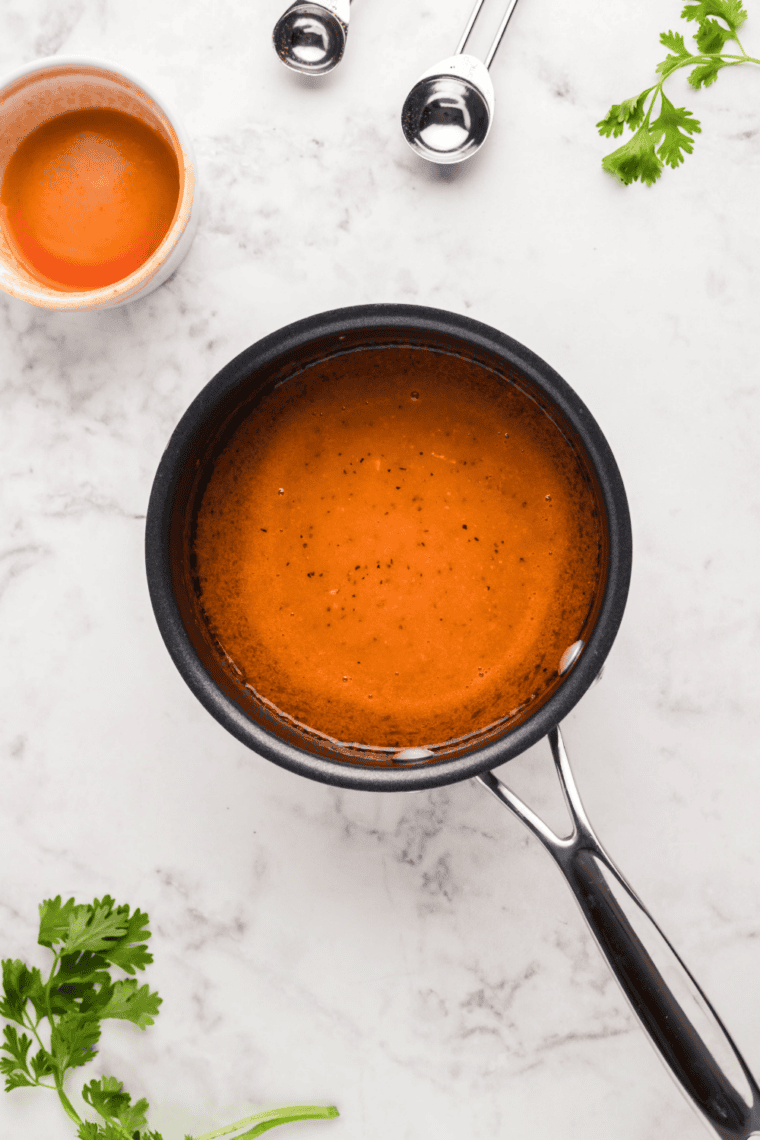 Buffalo sauce simmering in a saucepan