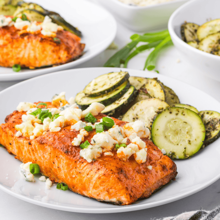 Buffalo salmon fillet glazed with hot sauce on a white plate