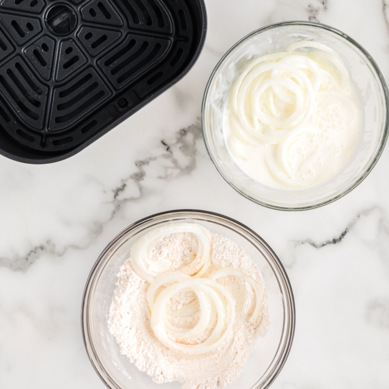 onions dredged in seasoned flour in a shallow dish
