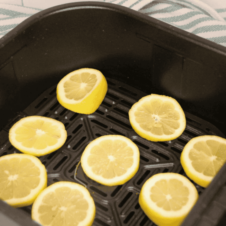 Fresh lemon zest spread on a parchment-lined baking sheet before drying in the oven