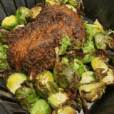 Santa Maria seasoned tri tip roast cooked in an air fryer basket with a browned peppery crust