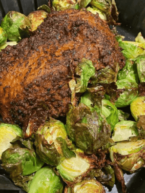 Santa Maria seasoned tri tip roast cooked in an air fryer basket with a browned peppery crust