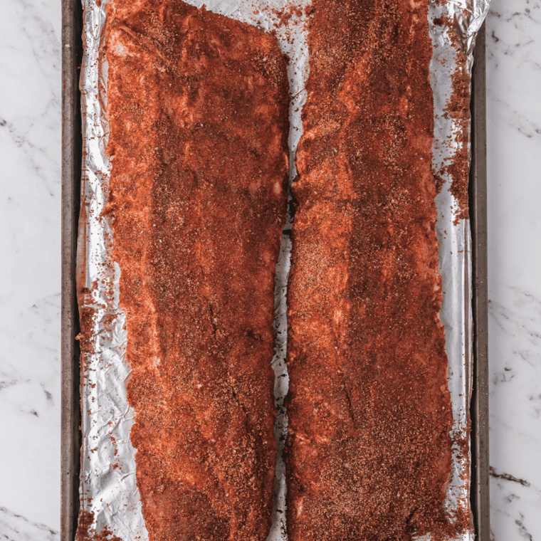 Rack of raw ribs coated with homemade Santa Maria seasoning rub