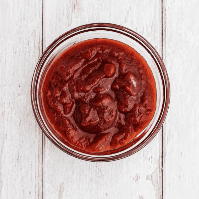 Whisking tomato paste into water in a glass bowl to start copycat Lawry's Baja Chipotle Marinade  