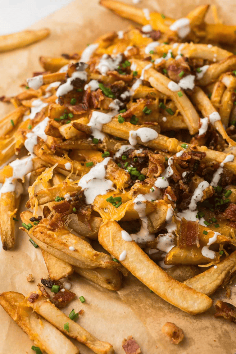 Overhead shot of copycat Outback Aussie cheese fries served family style with ranch for dipping