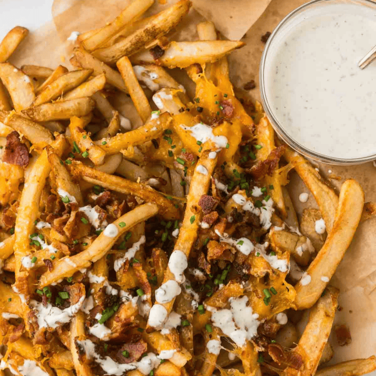 Melted cheese stretching from a serving of copycat Outback Aussie cheese fries