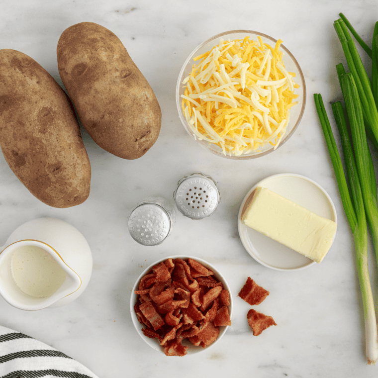 Ingredients for copycat Outback Aussie cheese fries including russet potatoes, Monterey Jack, sharp cheddar, thick-cut bacon, sour cream, and seasonings