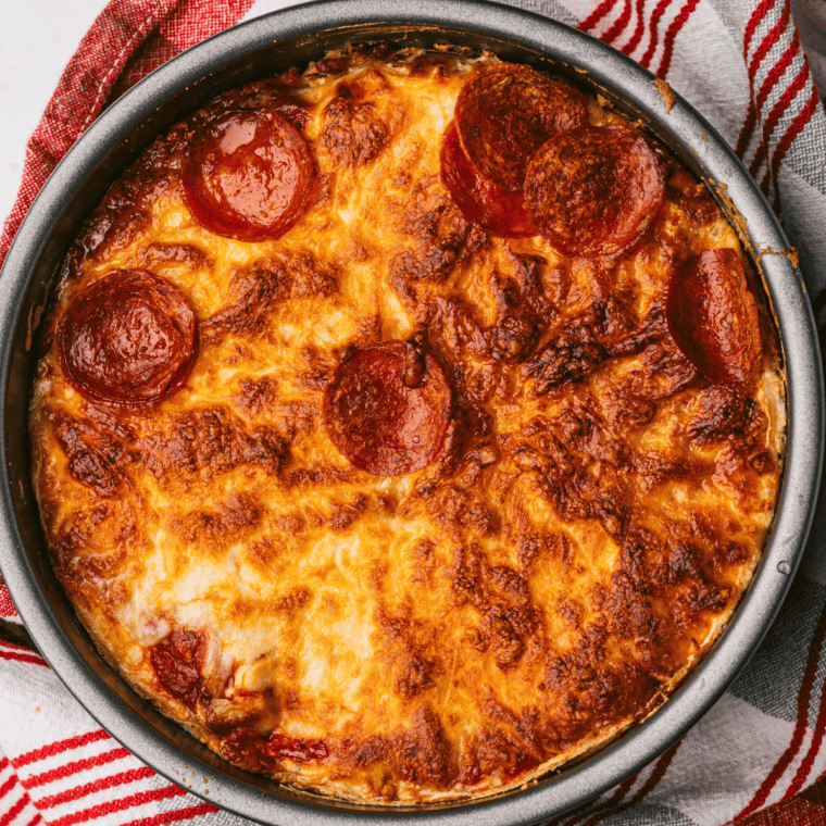 Golden pan pizza topped with pepperoni and bubbling mozzarella cheese
