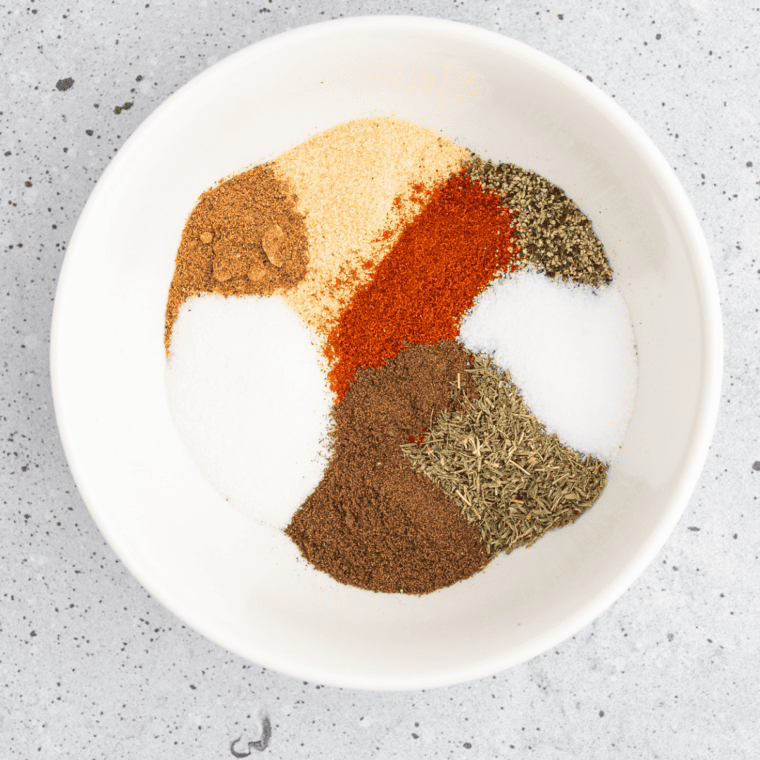 Kosher salt, black pepper, garlic powder, onion powder, paprika, parsley, and cayenne added to a small bowl