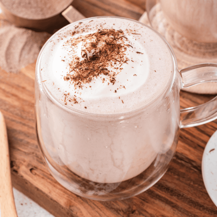 Copycat Wendy's Frosty-ccino poured into a tall glass and topped with whipped cream and chocolate drizzl