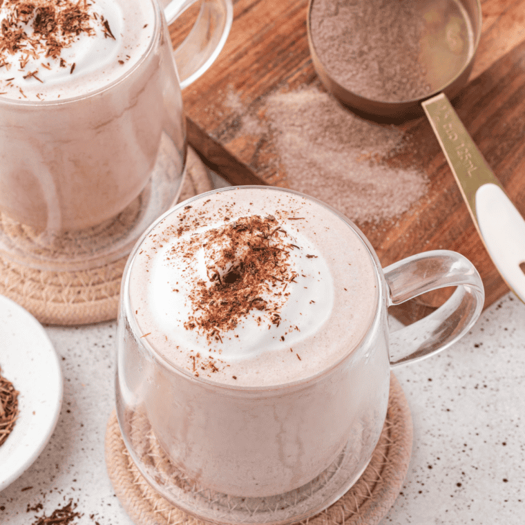 Creamy copycat Wendy's Frosty-ccino served in a tall chilled glass with a wide straw and whipped cream