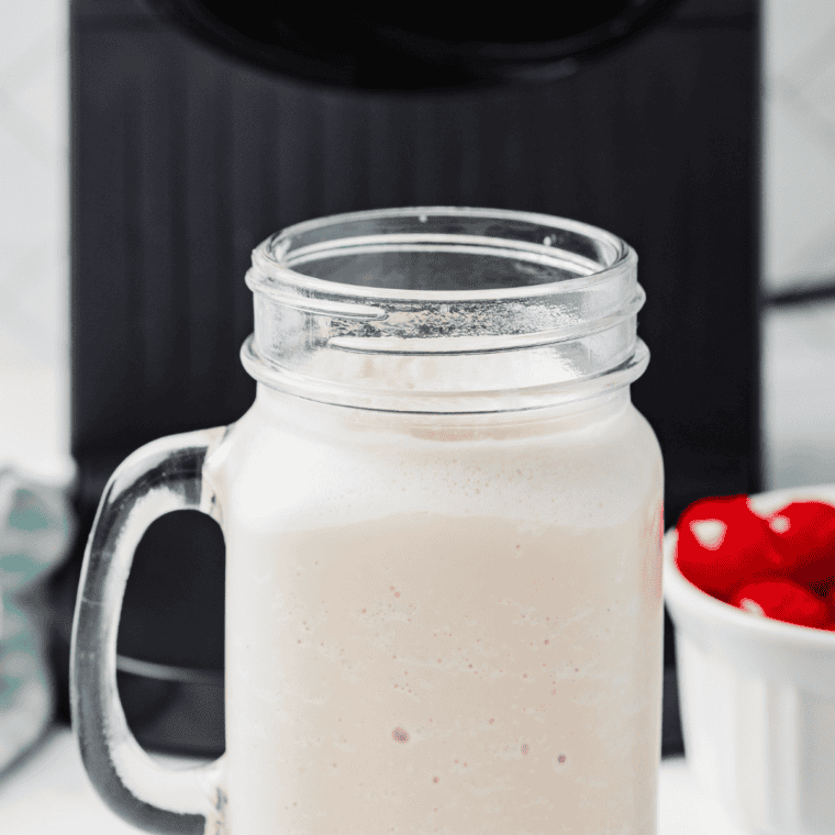 Copycat Wendy's Vanilla Frosty scooped into a cup, thick enough to hold a spoon upright