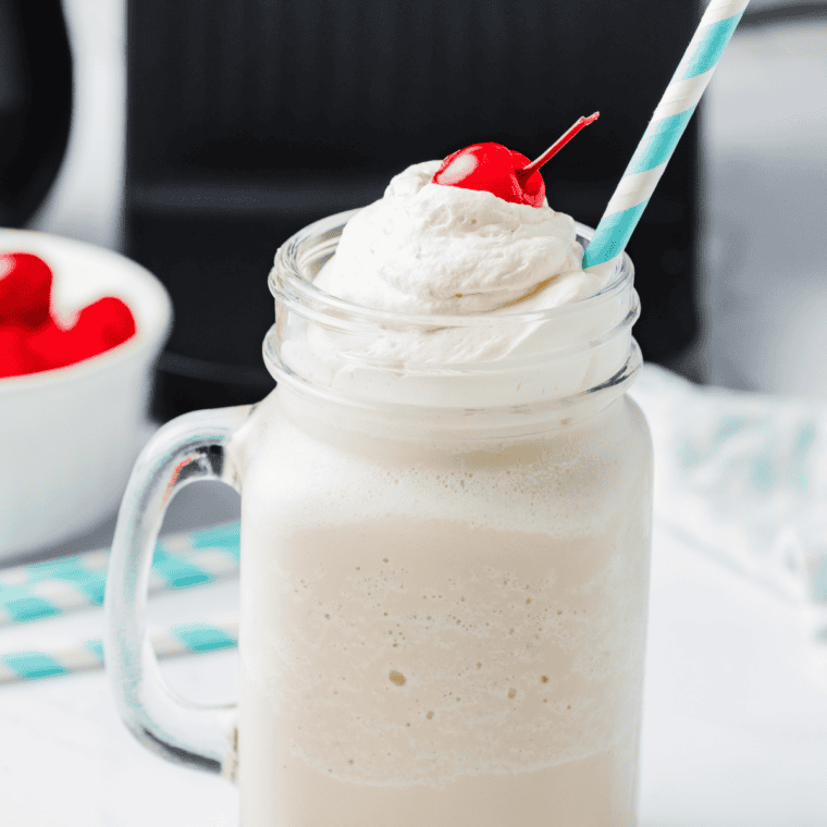 Thick copycat Wendy's Vanilla Frosty in a clear cup with a spoon standing upright in it