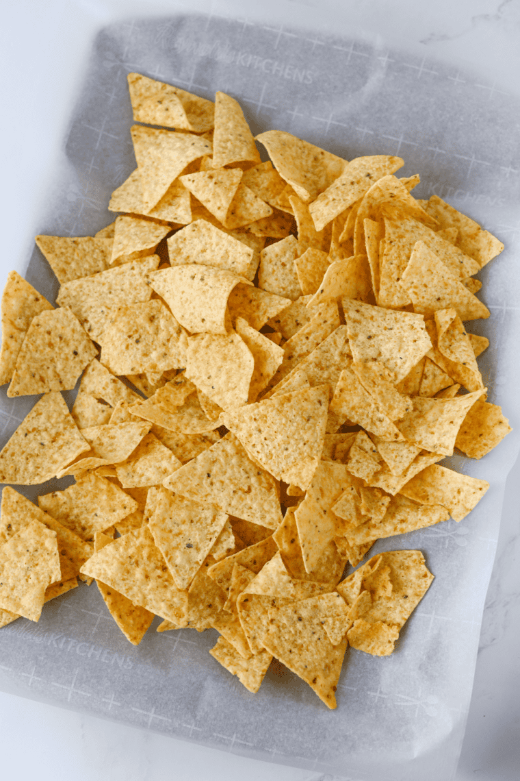 Large rimmed baking sheet lined with parchment paper for building nachos