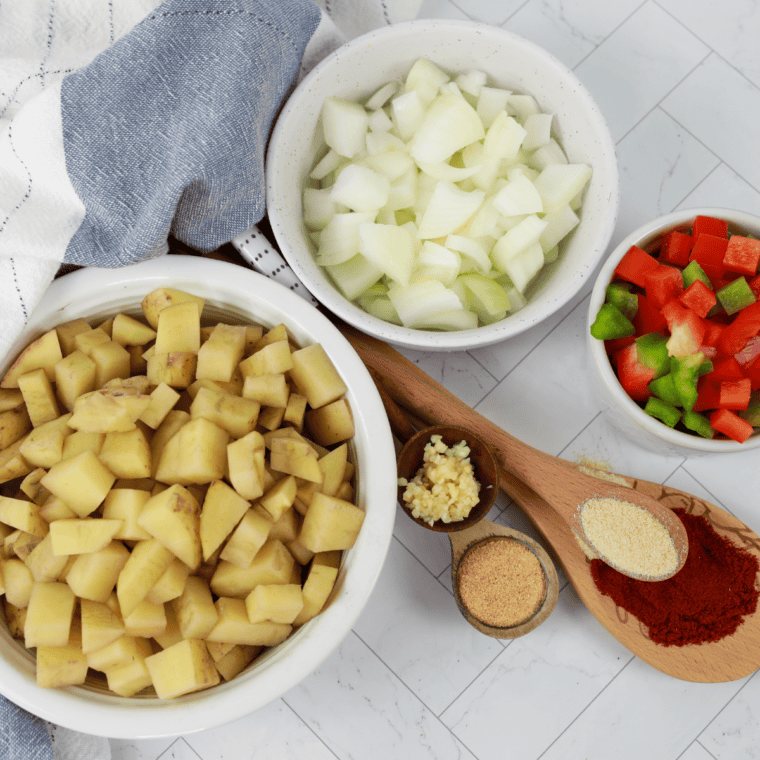 Red potatoes, onion, paprika, garlic powder and butter measured out for Denny's home fries