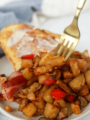 If you have ever ordered a Grand Slam and found yourself eating the potatoes first, this one is for you. Denny's home fries are the seasoned, red-skinned potatoes that show up under their skillets and beside their egg plates: crackly and browned on the outside, soft and almost creamy in the middle, and seasoned with a paprika-forward blend that tints them a warm orange.