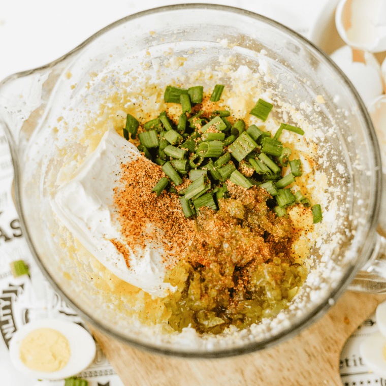 Cream cheese, Duke's mayo, relish, and Cajun seasoning added to blended eggs in a mixing bowl